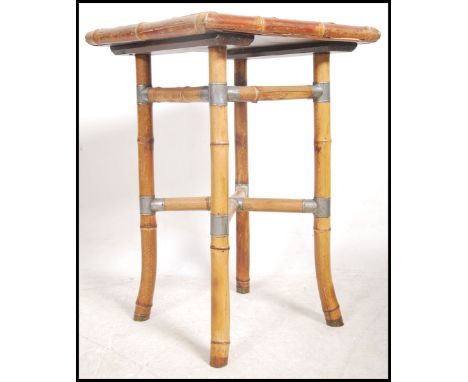 An early 20th century Aesthetic movement tile top occasional table. The top inset with blue and white tiles raised on bamboo 