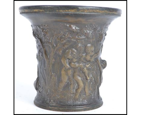 An 18th heavy century cast bronze pot decorated with classical figures of putti form. Measures 11cm high.