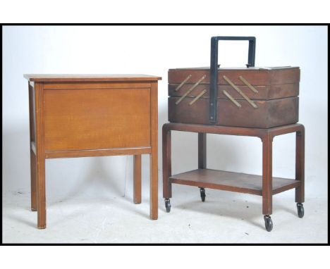 A good early 20th century vintage metamorphic sewing box with multiple sections with handle to centre complete with the conte