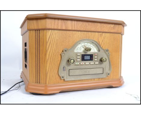 A vintage style wooden cased record player with hinged top having USB recorder, Cd player etc