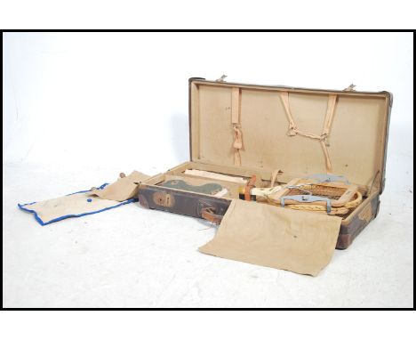 A vintage 1930's tennis set complete in the travel case to include 2 tennis rackets with stretchers, shoes, equipment etc all