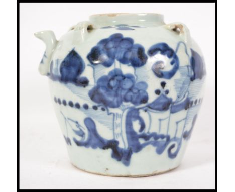 A Chinese blue and white Kang-xi period ceramic teapot decorated with trees, boats, waves and mountain scenes, character mark