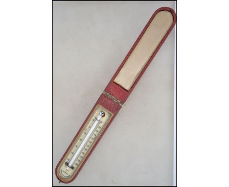 An early 20th century Negretti & Zambra of London cased travel thermometer. The thermometer set to ivorine back and within a 