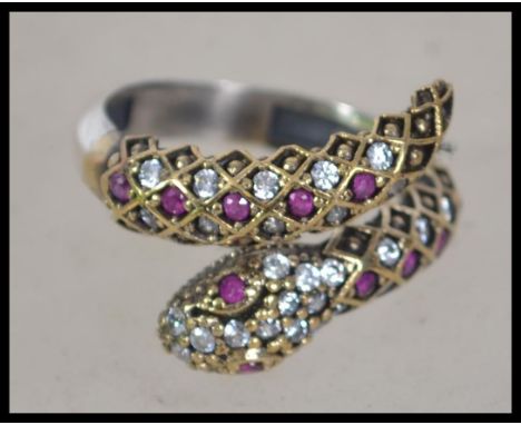 A ladies contemporary silver ring in the form of a snake being set with semi precious stones size adjustable.