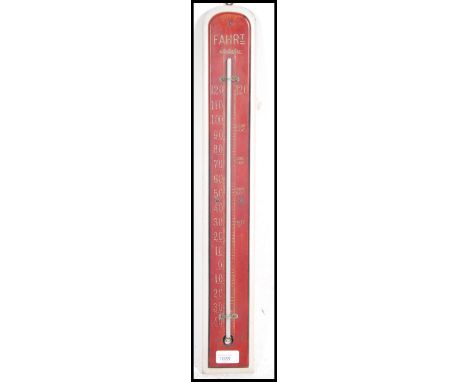 A vintage 20th century French wall mounted Thermometer having painted base with numerals the length of the mercury thermomete