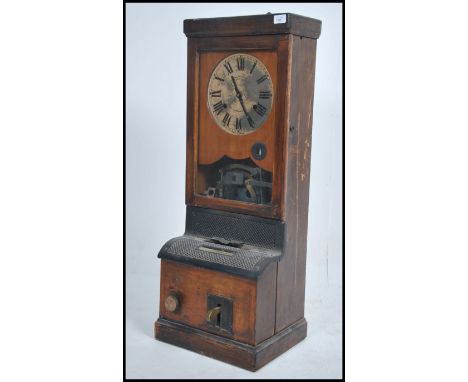 A vintage National time recorder dating to the early 20th century being set within oak case having brass dial with notation a
