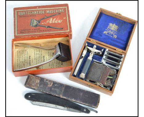 A vintage cased Wilkinson Sword seven day safety razor and leather strop together with other items.