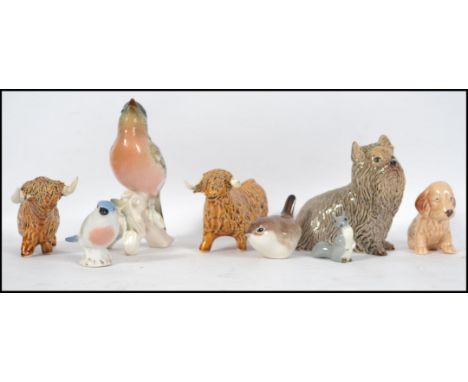 A collection of ceramic animal figurines to include Ussr, West German Goebbels, West Highland Cattle, Westie Scottie dogs etc