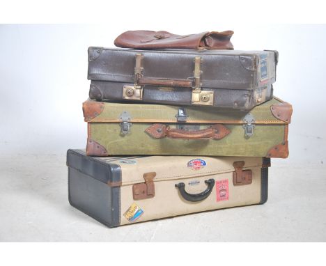 A stack of vintage 20th century travel cases/ suit cases to include leather examples.