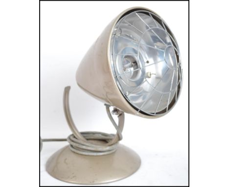 A retro mid 20th century heat lamp, having a circular base with an atomic shaped conical shade, makers mark for Barber.