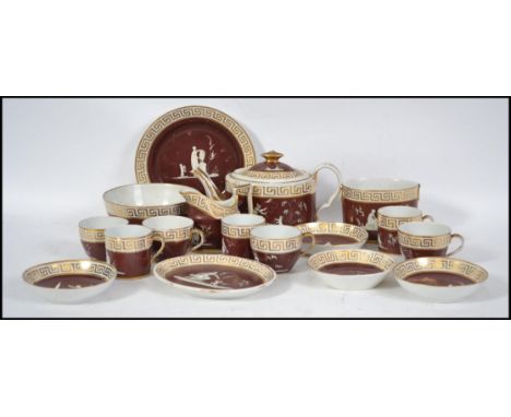 A believed 19th century ceramic tea service in the Napoleonic style with greek key decoration on red ground with cameo style 