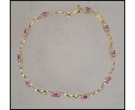 A ladies 14ct gold and ruby bracelet complete in the presentation case4.3 grams.