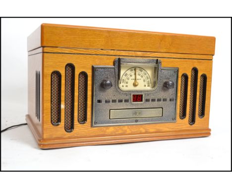 A Crosley vintage style wooden cased record player having hinged top with cd player and tape deck