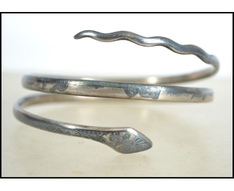 A Siam silver slave bangle in the form of a snake having etched decoration to the body with inside marked Marian, Total weigh