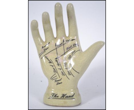 A 20th century ceramic fortune lines / fortune tellers hand. Measures 20cm high.