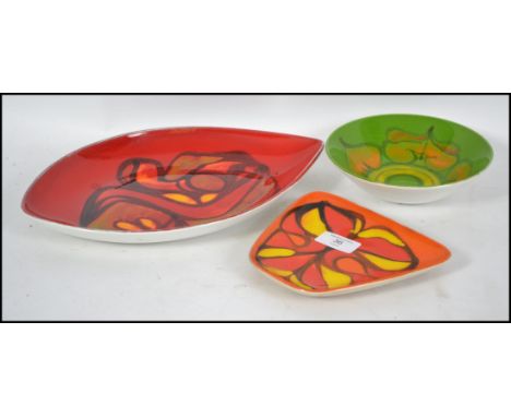A group of three 20th century retro Poole Delphis pattern items to include a green glazed bowl (56) a red glazed dish (81) an