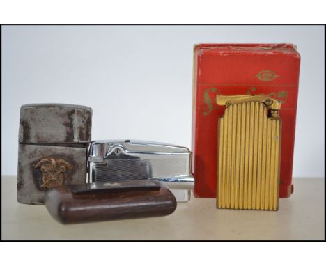 A pre-war circa 1930's - 1940's Zippo lighter with markings to base and patent no 2032695 together with 2 other lighters to i