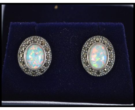 A pair of silver marcasite and opal stud earrings complete in the original presentation case