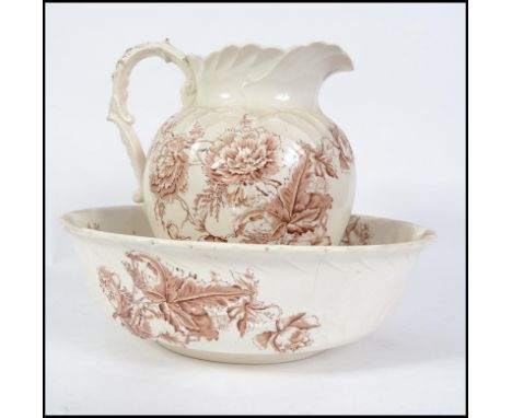 A 19th century Staffordshire transfer printed ceramic wash bowl and jug in a brown colourway. The jug measures 30cm high.