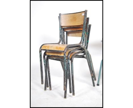 A set of four vintage mid 20th century French stacking chairs. The chairs having metal tubular frames with fitted panel seats