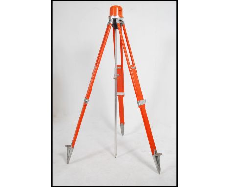 A vintage 20th century industrial orange painted wooden and aluminum surveyors adjustable tripod stand.&nbsp;Measures height 