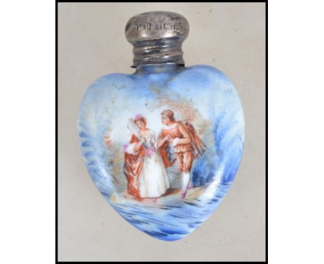 A silver and ceramic heart shaped ladies perfume bottle. The silver top hallmarked for Birmingham 1903 by possibly Robert Pri