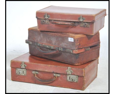 A vintage early 20th century leather doctors gladstone bag together with 2 vintage leather suitcases, each with carry handles