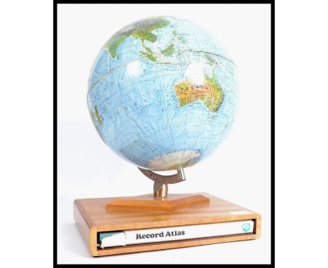 A vintage 20th century retro desk top globe raised on wooden plinth with recess for book / atlas&nbsp;