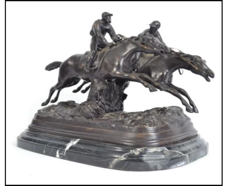 Believed E. Loiscau, a 20th century large bronze figurine diorama being modelled as two racehorses with riders jumping a fenc