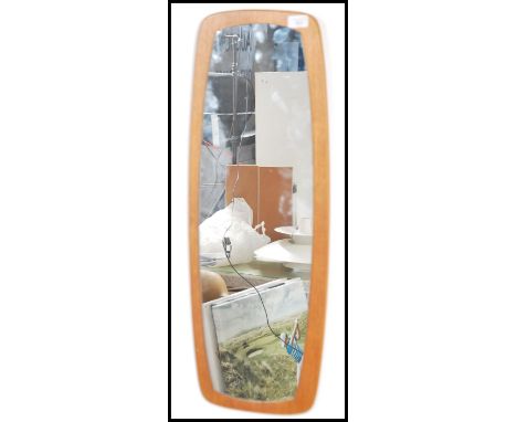 A vintage mid century teak wood backed frameless wall mirrors of atomic style form.&nbsp;Measures height 77cm x width 29cm.
