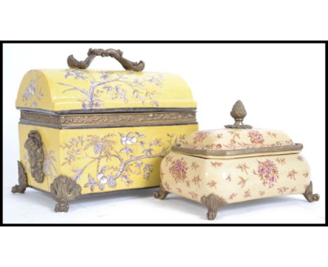 A pair of stunning ceramic lidded dishes the larger having a hinged dome top lid with stunning gilt decoration raised on gilt
