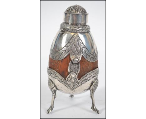 A silvered covered Matte drinking gourd. The gourd having a fret pierced silver metal cover. Raised on tripod feet. Weighs 20