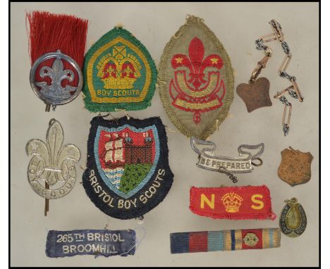 A collection of vintage Boy Scouts badges and patches to include various shapes and designs, silver boy scout badge with Lond