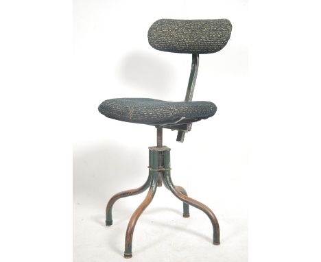 A vintage mid century Industrial swivel chair raised on tubular metal frame with 4 legs having upholstered seat and back rest