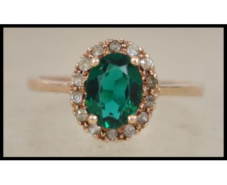 A 9ct gold ladies ring inset with green and clear stones ( see illustrations )