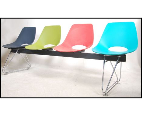 A contemporary Charles &amp; Ray Eames style 4 seat bench by Merryfair having chrome DSW style eiffel supports with multicolo