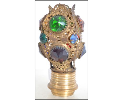 An early 20th century fret pierces brass light fixture having inset coloured stones to the panels.&nbsp;