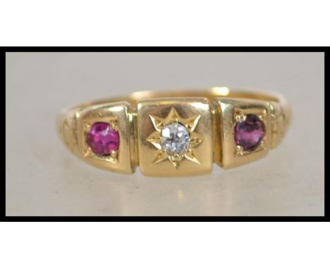 An early 20th century 18ct gold ruby and diamond ring with central star set diamond (approx &nbsp;5pts) flanked by two rubies