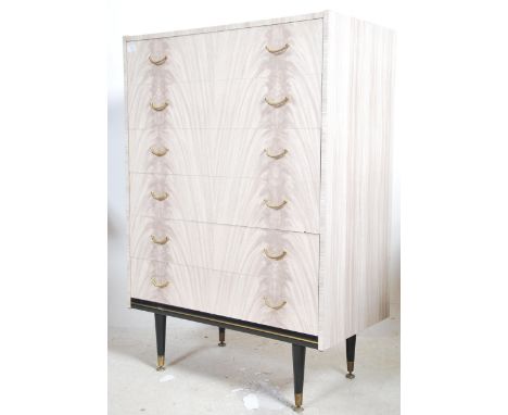 A vintage mid 20th century melamine straight six chest of drawers, brass handles and raised on tapering ebonised legs.&nbsp;M