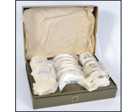 A 20th century presentation boxed Royal Worcester tea service in a chintz pattern, remaining in individual packing within, al