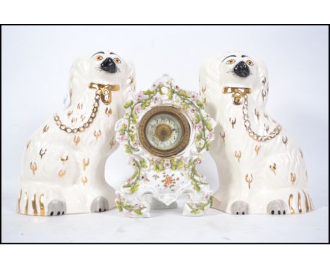 2 early 20th century Staffordshire Beswick Spaniel ceramic figurines with white glaze being stamped to the underside. The tal