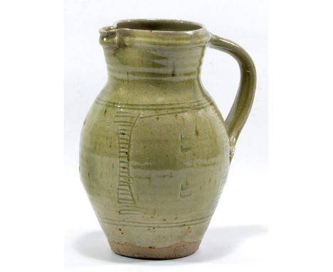 JIM MALONE (born 1946); a stoneware jug covered in green ash glaze with incised decoration, impressed JM mark, made 1976-82, 