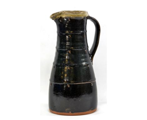 JIM MALONE (born 1946); a tall tapered stoneware jug covered in tenmoku glaze with green ash rim and interior, impressed JM a