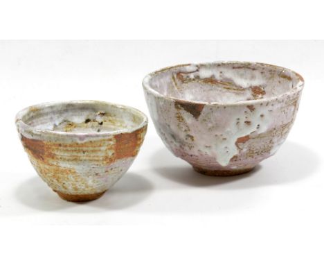ROBIN WELCH (born 1936); two small stoneware bowls, white and lilac glaze pooling to bright red in the well, impressed RW mar
