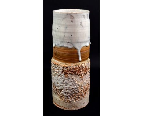 ROBIN WELCH (born 1936); a cylindrical stoneware vase, running white glaze over central band of ochre with textured base, imp