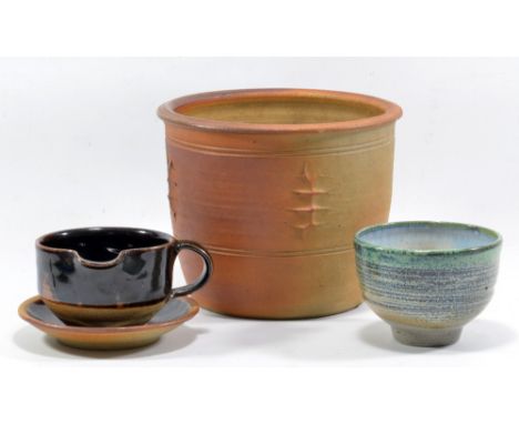 RAY FINCH (1914-2012) for Winchcombe Pottery; a stoneware gravy boat and saucer and a tea bowl, impressed WP. marks, and a Wi