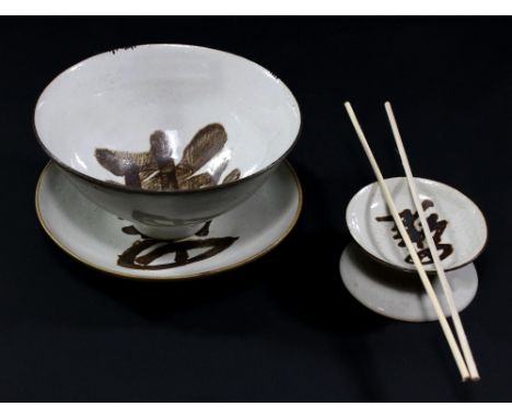 LUCIE RIE (1902-1995); a stoneware 'Rijsttafel' trio comprising a rice bowl, plate and chop-stick stand, off white pitted gla