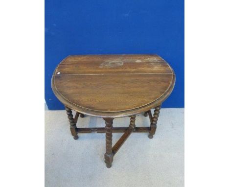 An oak gateleg table raised on bobbin turned supports. 