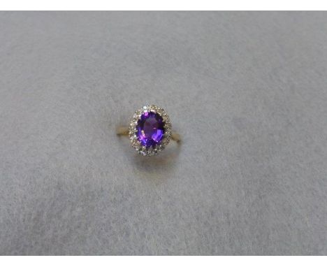 An 18ct gold amethyst and diamond ring, size O. 