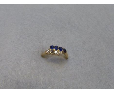 A 9ct gold sapphire and diamond ring, size J/K. set with four sapphire and four diamonds.